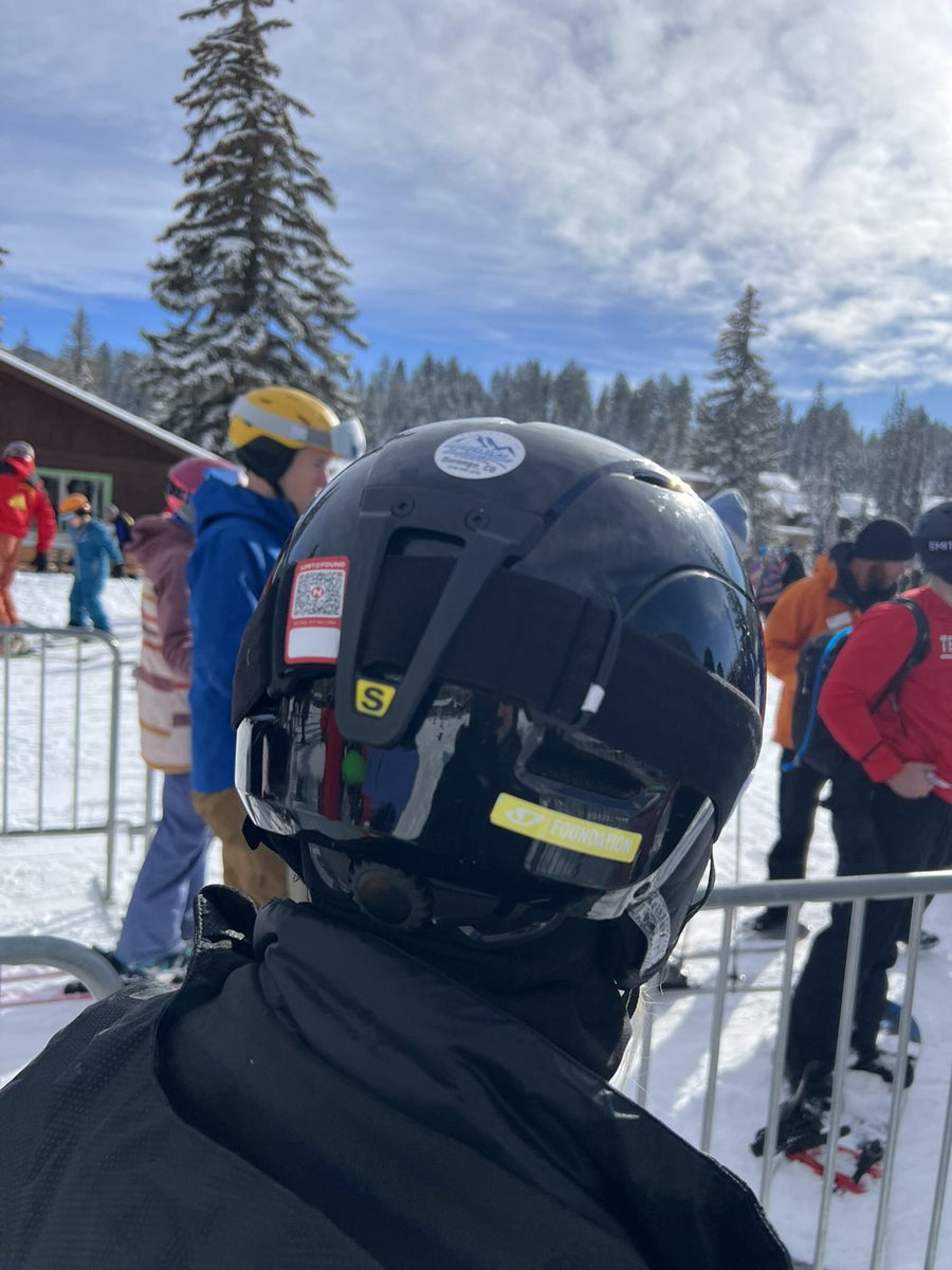 The back of a ski helmet with a Lost N Found QR return tag